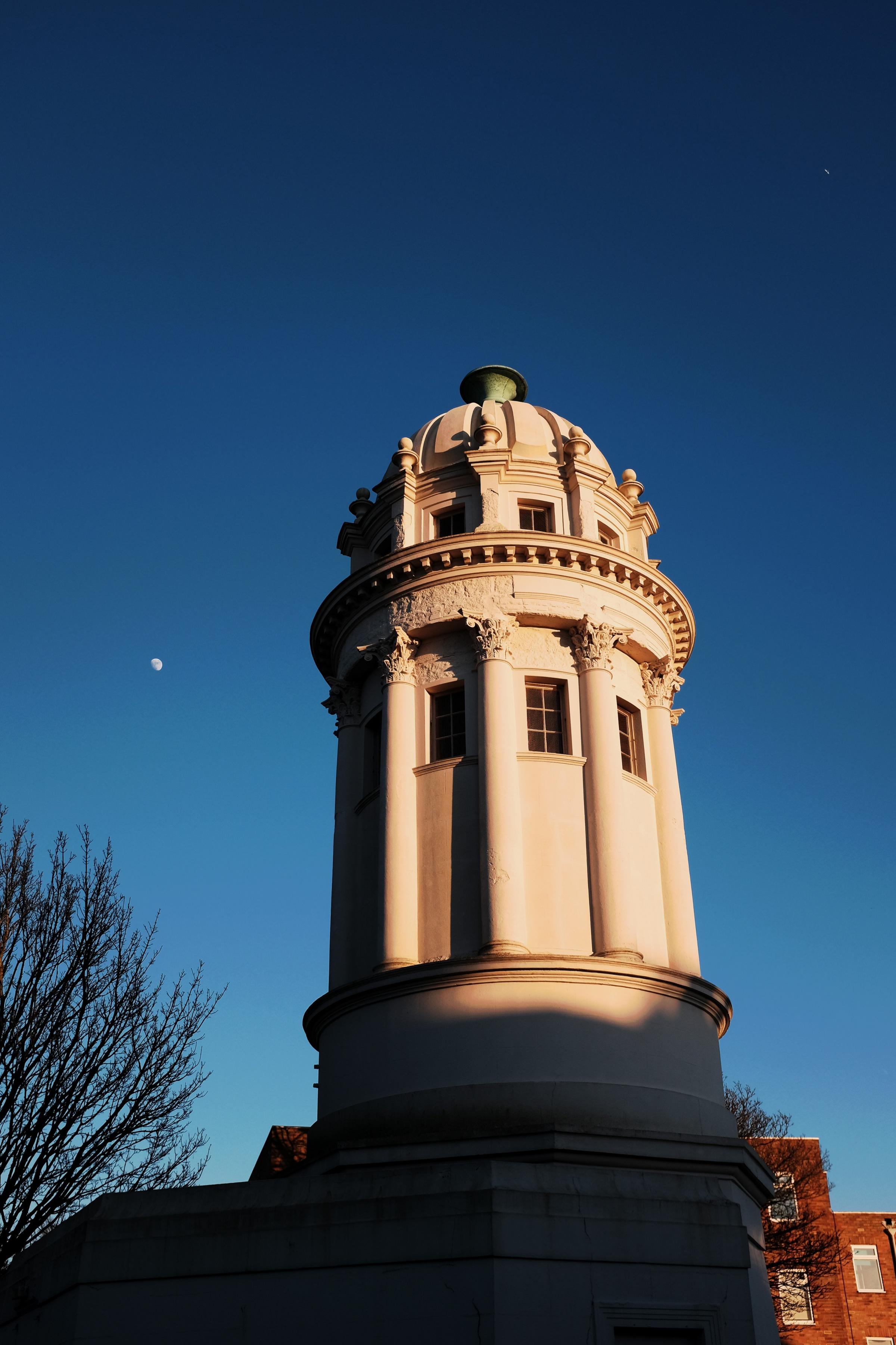 Brighton UK 18th February 2016 - The Pepper Pot or Pepperpot at the north end of Queens Park in winter sunshine with the moon visible at the top left A Grade II listed building designed by Sir Charles Barry in 1830 and originally stood in the grounds of